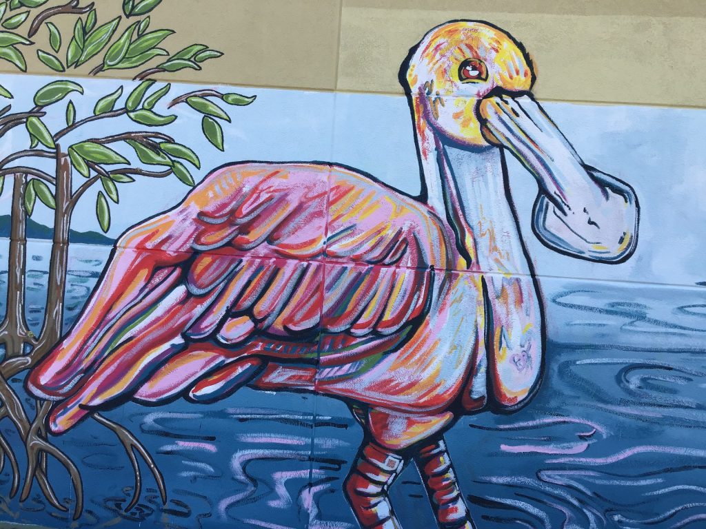 Spoonbill with mangroves behind it, painted as part of a mural on the library outside wall. 
